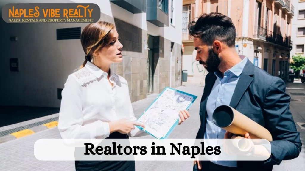 Two Realtors in Naples discussing property details outdoors. The female realtor is holding a blueprint, while the male realtor carries rolled-up documents.